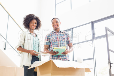 Young couple unpacking carton boxes