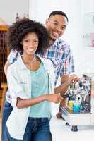 Young couple preparing coffee from coffeemaker