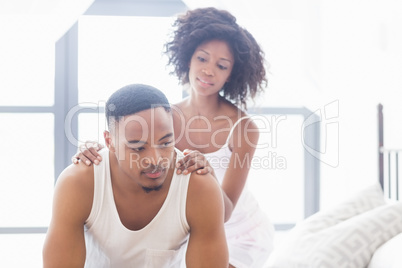 Woman comforting her man in bedroom