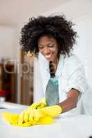 Woman cleaning kitchen counter