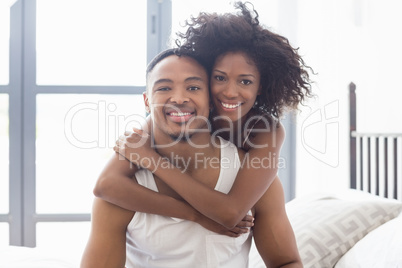 Young couple embracing each other in bedroom