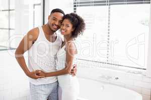 Young couple embracing each other in bathroom