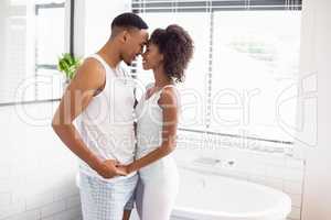 Young couple embracing each other in bathroom