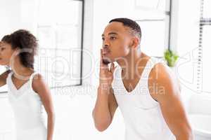 Couple checking their skin in bathroom