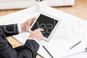 Businessman using digital tablet at desk