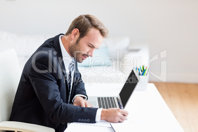 Businessman using laptop at desk