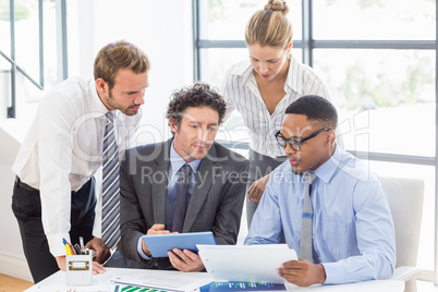 Business colleagues discussing a report