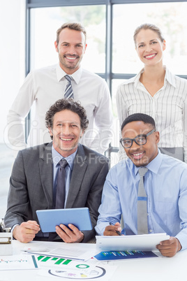 Portrait of happy business colleagues standing together