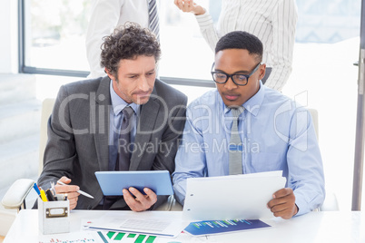 Business colleagues discussing a report Business colleagues discussing a report