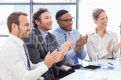 Businesspeople applauding while in a meeting
