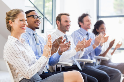 Businesspeople applauding while in a meeting