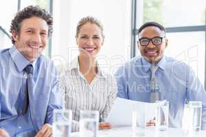 Portrait of businesspeople smiling in meeting