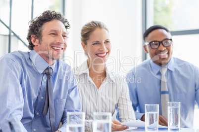 Businesspeople smiling in meeting