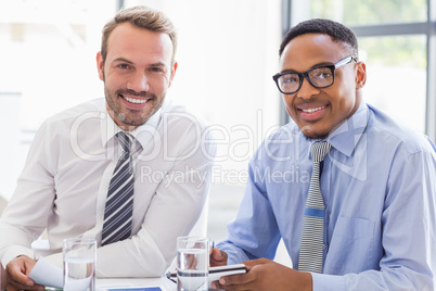 Portrait of businesspeople smiling in meeting