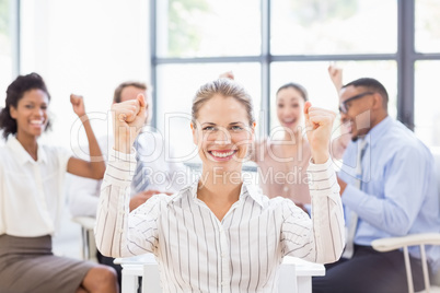 Portrait of businesswoman celebrating success with her colleague