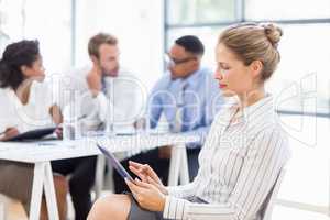 Businesswoman using digital tablet in office