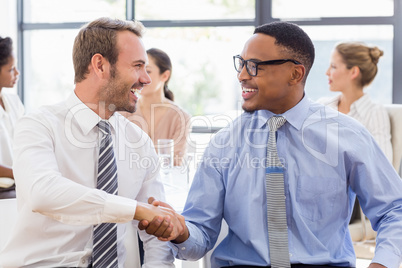 Business colleagues shaking hands during a meeting