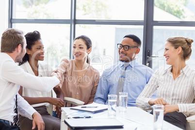 Business colleagues shaking hands during a meeting