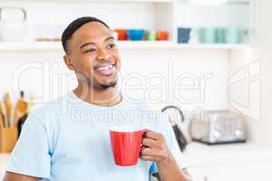 Happy man holding a cup of coffee