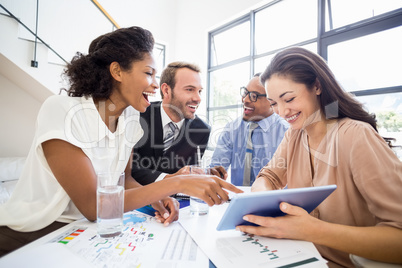 Businesspeople laughing in a meeting