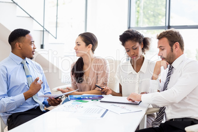 Businesspeople discussing a report