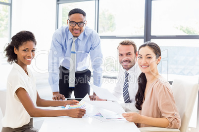 Businessmen and businesswomen discussing a report