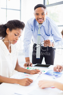 Businesspeople looking at reports in meeting