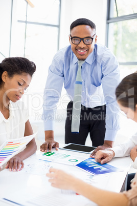 Businesspeople looking at reports in meeting