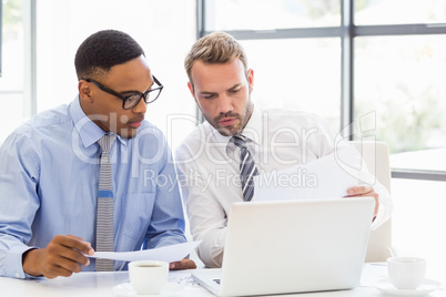 Businessmen discussing a report