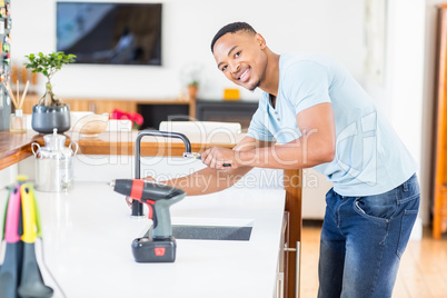 Man tightening tap with a wrench