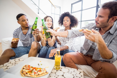 Friends toasting beer bottles