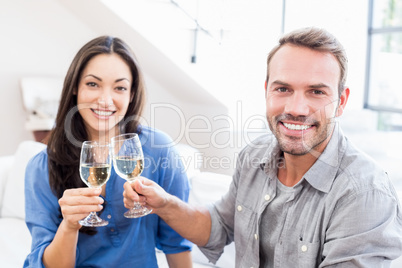 Young couple toasting wine glasses