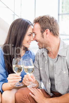 Young couple toasting wine glasses