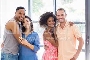 Friends embracing each other in living room