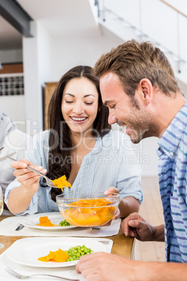 Young woman serving food on plate