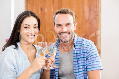 Young couple toasting wine glasses