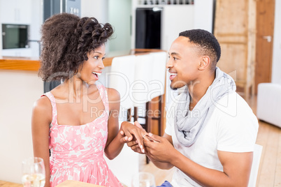Man gifting finger ring to his woman