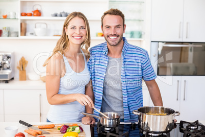 Young couple preparing a meal in kitchen