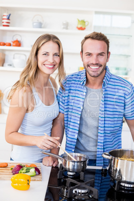 Young couple preparing a meal in kitchen