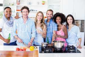 Group of friends standing in kitchen