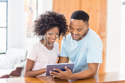 Happy couple using digital tablet