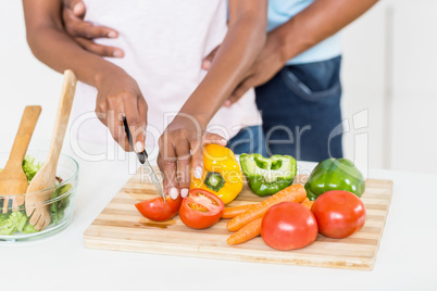 Woman cutting vegetables on chopping board