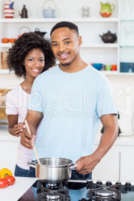 Young couple preparing a meal in kitchen