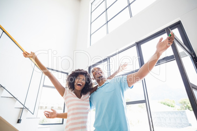 Excited young couple in their new home