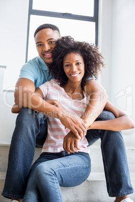 Young couple embracing on steps