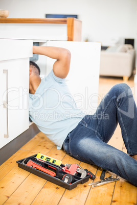 Man repairing a kitchen sink