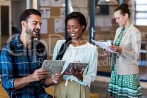 Young man and woman discuss using digital tablet