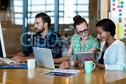 Young man and women sitting at their desk