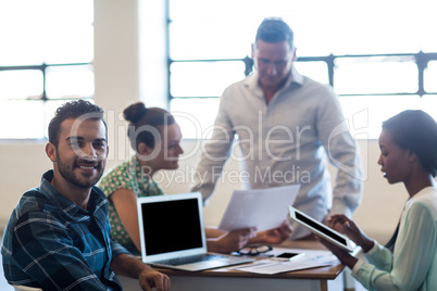 Young man and women sitting at their desk