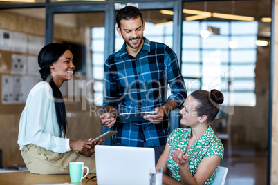 Young man and women sitting at their desk